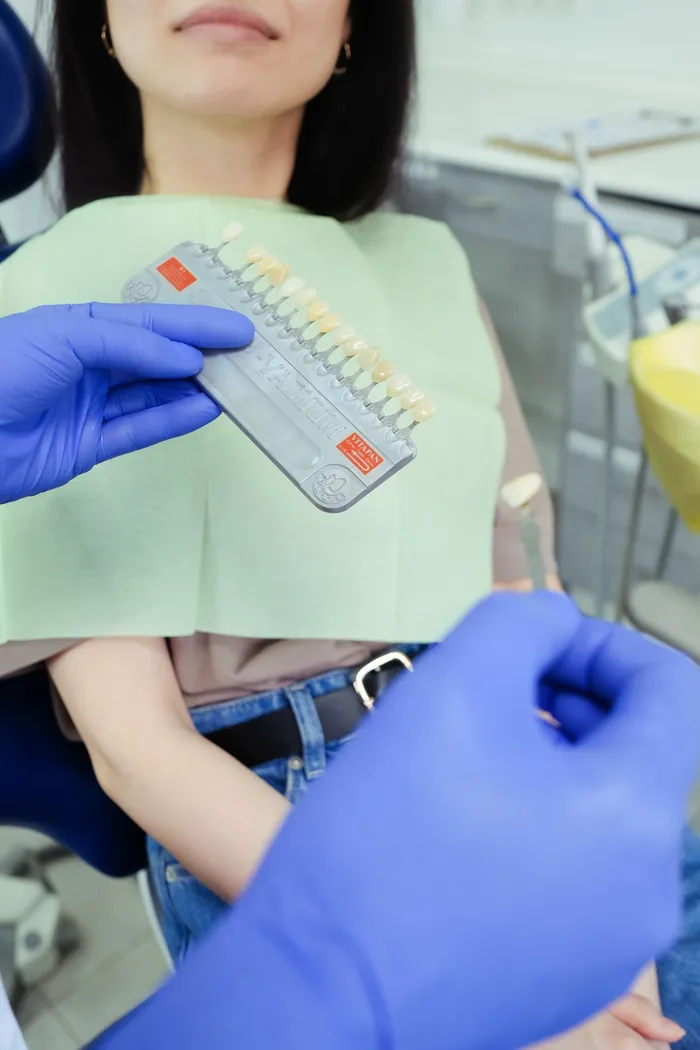 Dentist conducting a shade and colour consultation at Taki Dent — ensuring precise veneer and crown colour matching for every patient