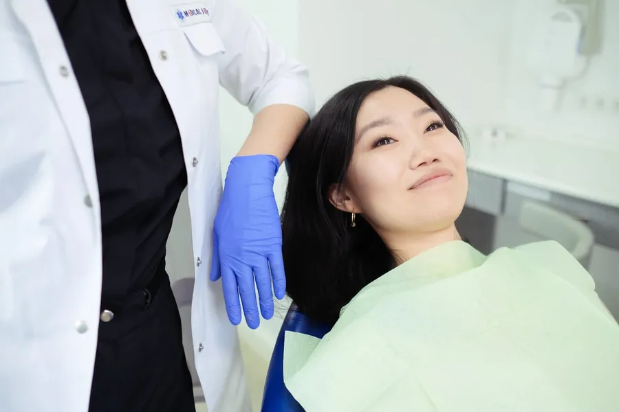 Patient with a brighter smile after professional laser teeth whitening at Taki Dent