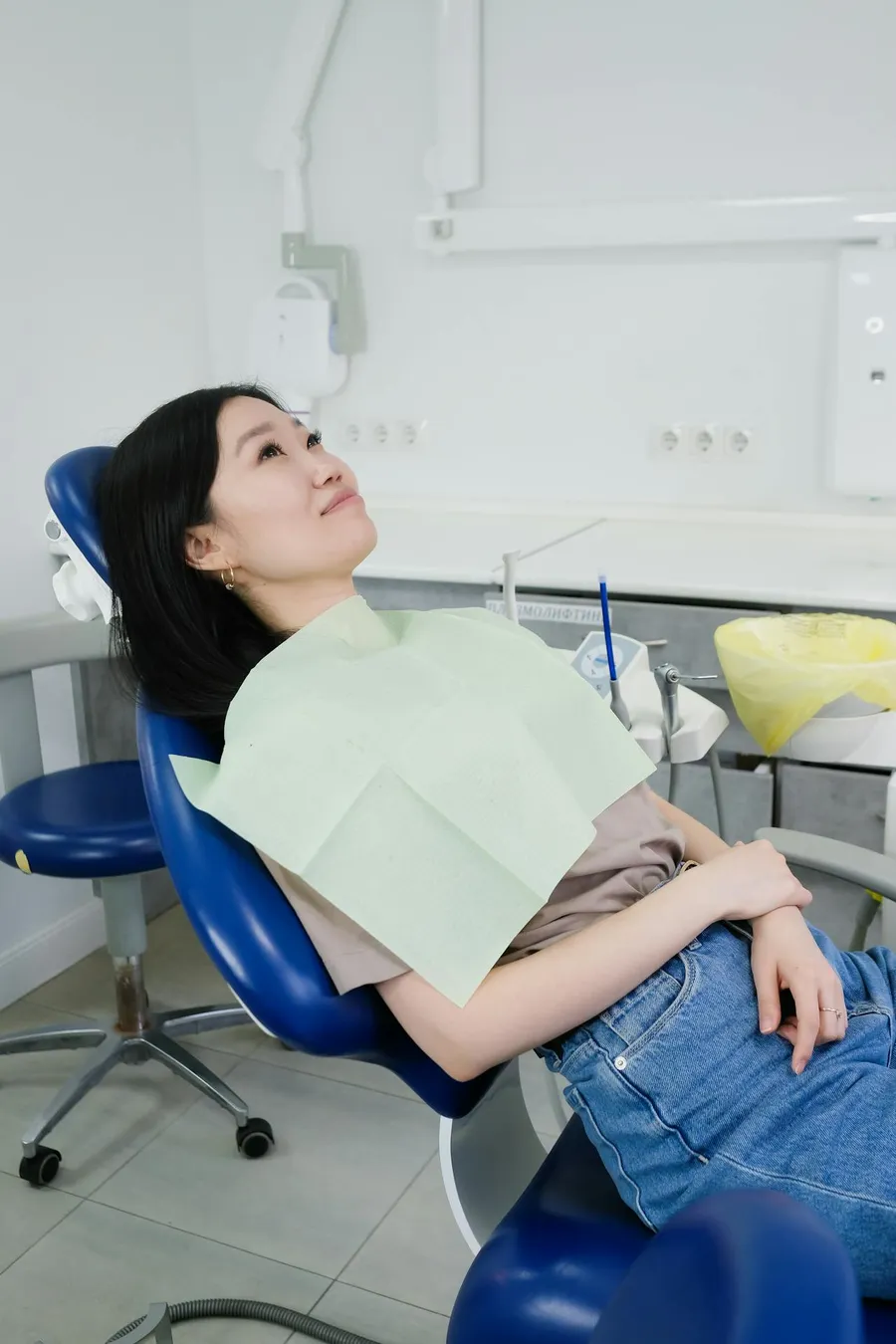 A woman relaxed and comfortable in a dental chair at Taki Dent — the calm, patient-centred environment that makes UK patients feel at ease throughout treatment
